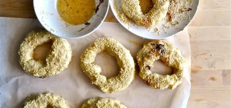 Step 3.1: Dip each bagel in the egg wash and then coat both sides in the seeds