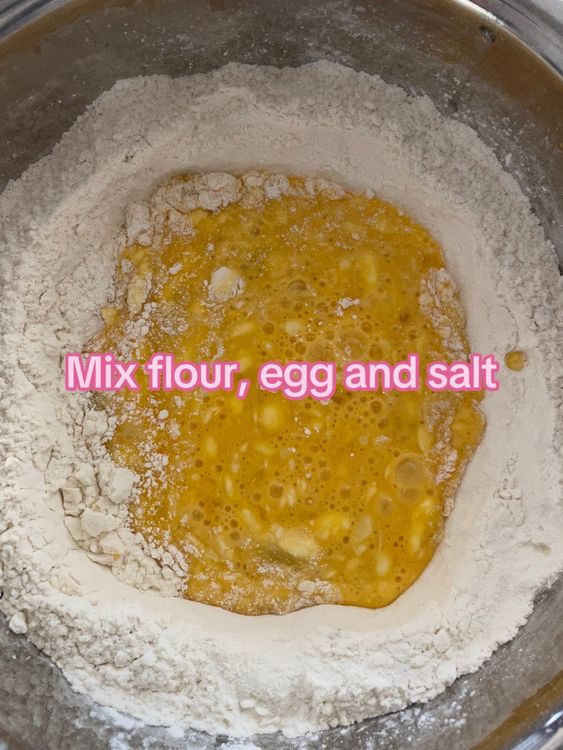 Step 1.1: Make a hole in the center of the flour, add eggs, salt, and olive oil