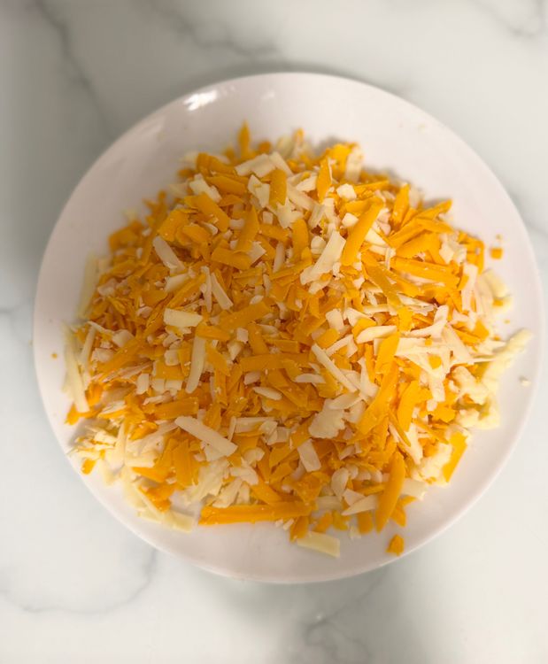 Step 1.1: Lower the heat and stir in 3/4 of the grated cheese, reserving the rest