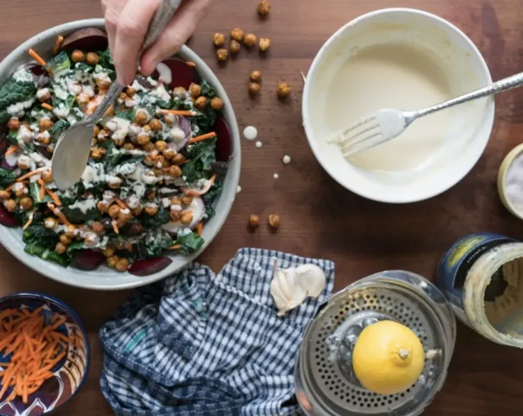 Step 4.1: Remove the roasted chickpeas from the oven, let cool slightly, sprinkle on top of the salad, and drizzle dressing over top