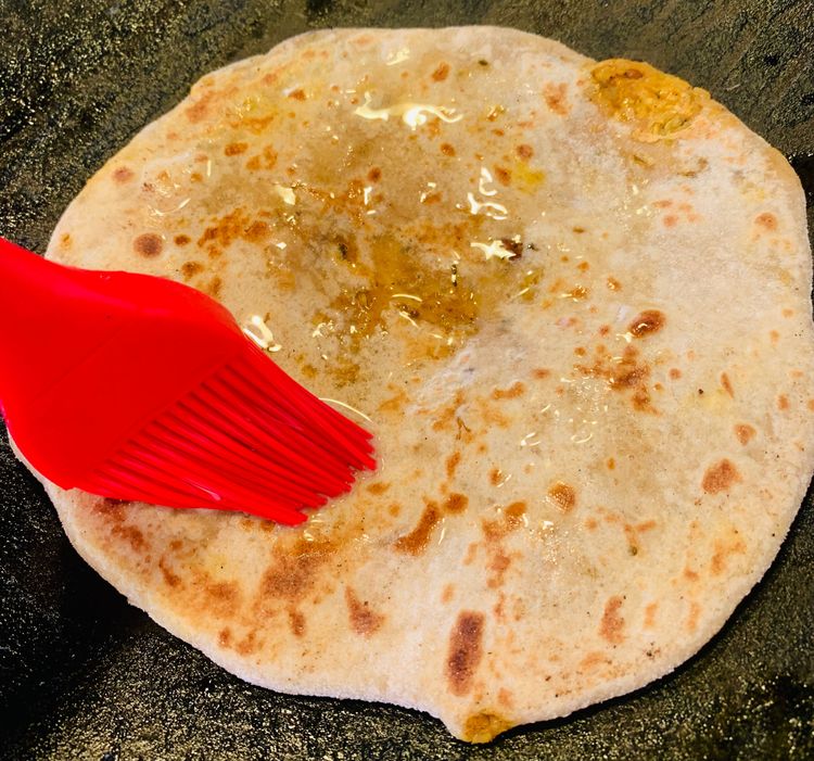 Step 2.1: Cook the paratha for a minute or until it starts to puff up