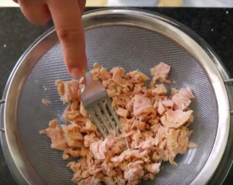 Step 2.1: Drain the canned tuna and flake it using a fork to remove excess liquid