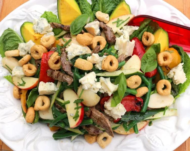 Step 3.1: Top the salad with the crumbled Gorgonzola Cheese, Fresh Basil Leaves, Tarallini, and the sliced Fresh Chives