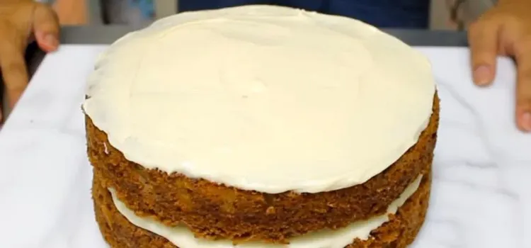 Step 3.1: Spread cream cheese frosting onto the flat side of the first cake