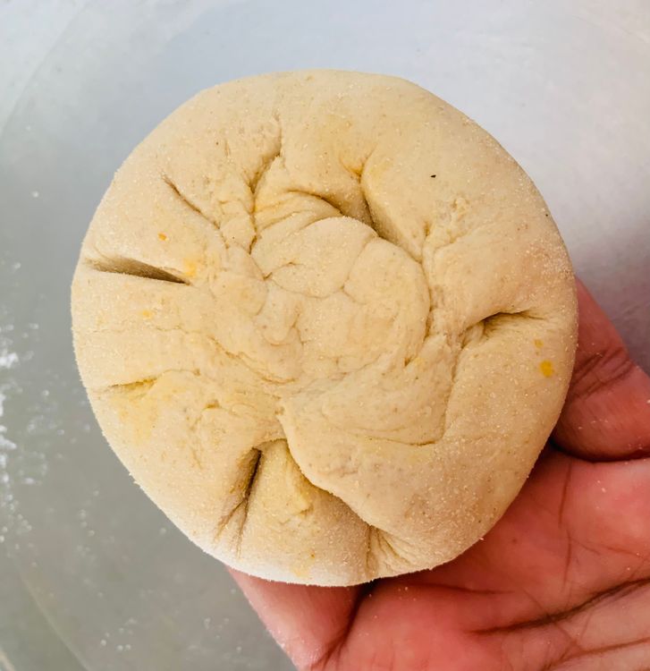 Step 2.2: Take one ball of dough and roll it into a small circle using a rolling pin