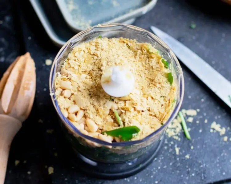 Step 1.1: Add wild garlic, 2 tbsp of pine nuts, nutritional yeast, olive oil, garlic, lemon juice, and salt to a small food processor