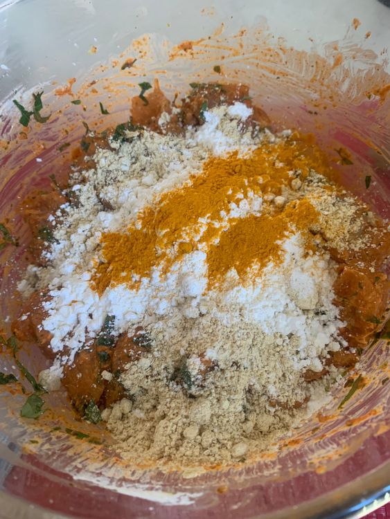 Step 2.1: After marinating, sprinkle gram flour, cornflour, and turmeric powder over the marinated chicken