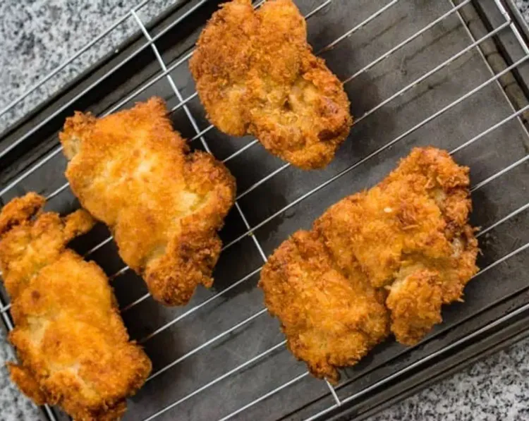 Step 2.1: Place the fried chicken on a cooling rack over a baking sheet, or on oil-absorbing paper
