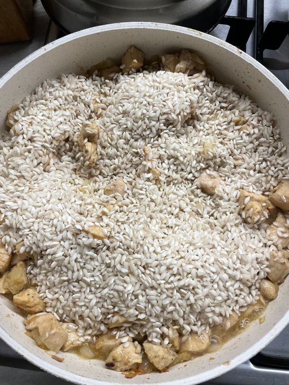 Step 1.1: Add the risotto rice to the pan and stir well