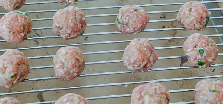 Step 2.1: Take out a small portion of the meat mixture, roll into balls, and place on a rack on top of a baking tray