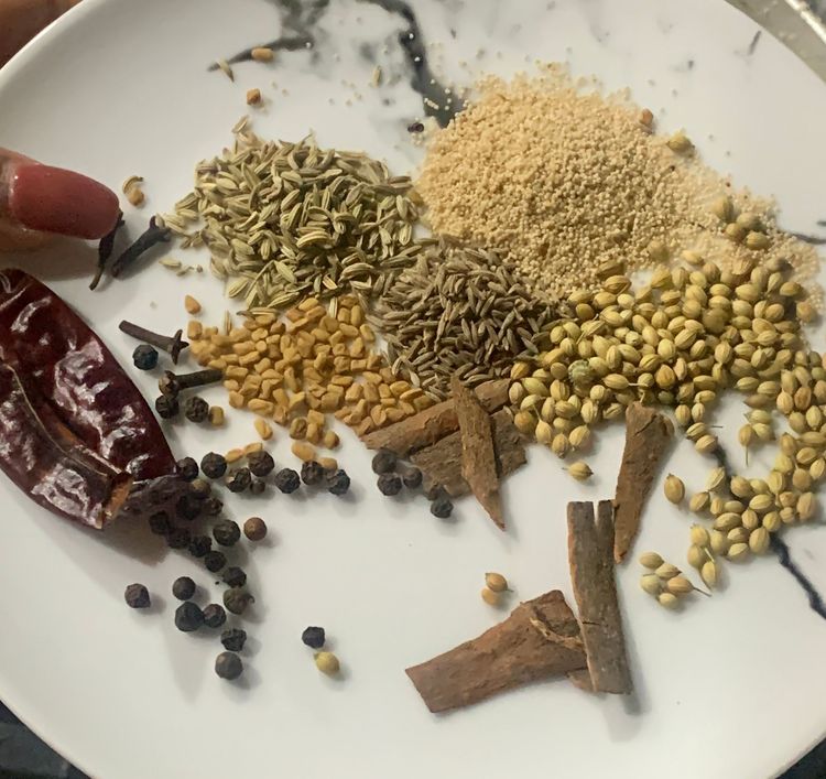 Step 1.1: In the same skillet, dry roast the cinnamon stick, peppercorns, cloves, fenugreek seeds, cumin, fennel seeds, coriander seeds, poppy seeds, and dry red chillies until fragrant