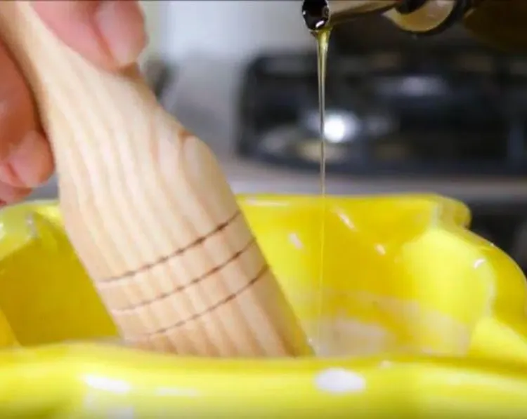 Step 1.1: Slowly pour in the olive oil while continuing to mix