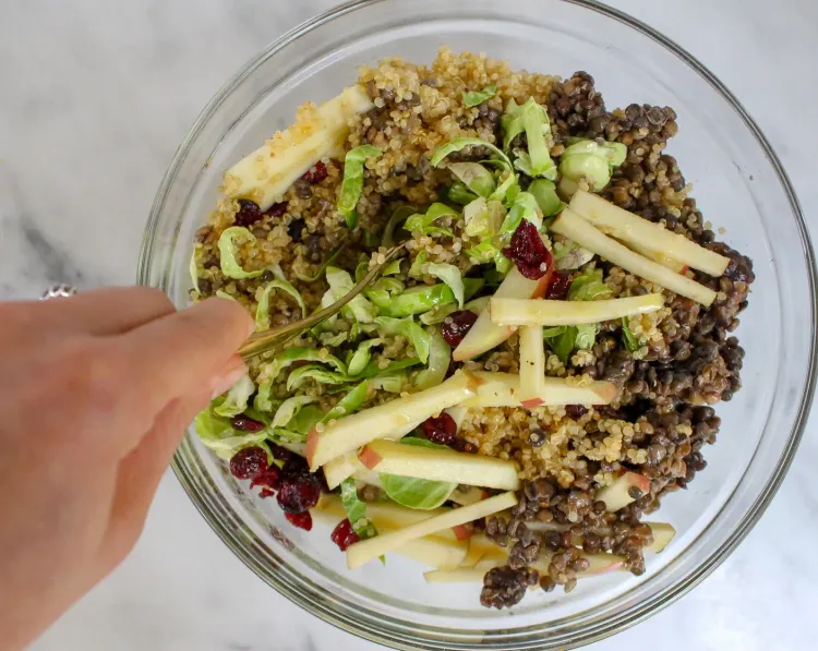 Step 5.1: Once the lentils and quinoa finish cooking, add them to the large bowl with Brussels sprouts