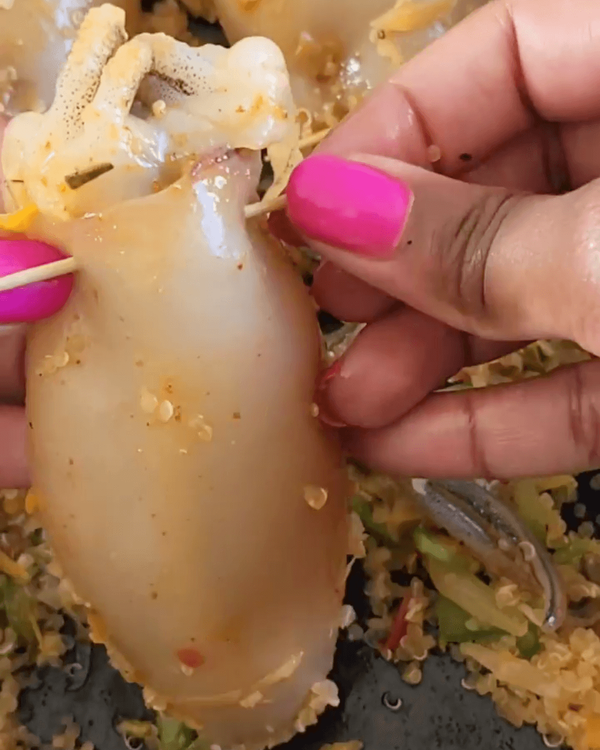 Step 2.2: Fill squid pockets 3/4 full with the quinoa mixture and secure with a toothpick