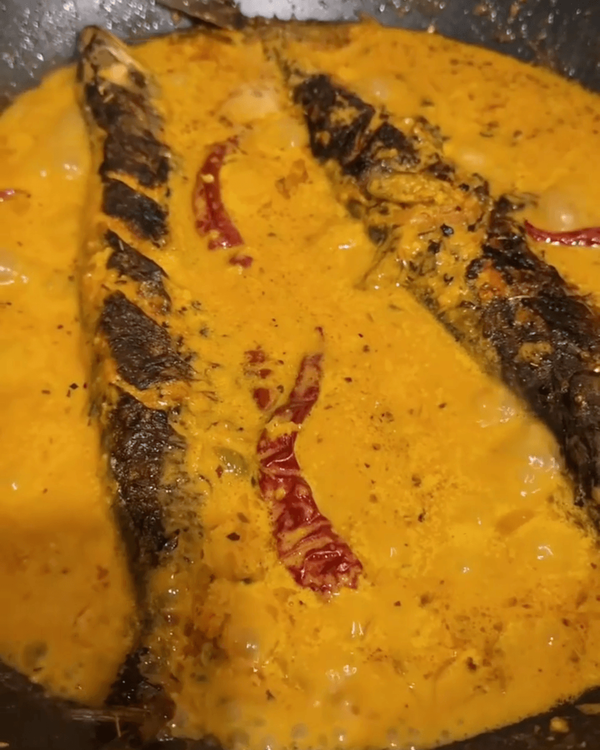 Step 4.1: Pour the coconut paste over the fish and gently mix to avoid breaking the fish