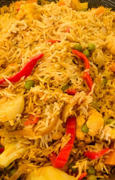 Step 1.1: Once the rice is cooked, gently mix the rice and vegetables with a spoon or flat ladle