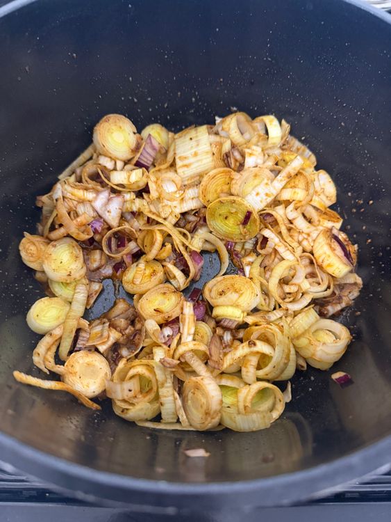 Step 2.1: In the same pot with the chicken juices, add onion, leeks, and garlic