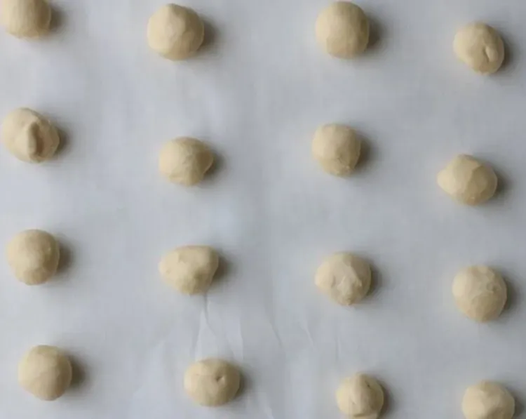 Step 2.1: Scoop out 1 tablespoon of dough at a time, roll into balls, and space evenly about 2 inches apart on prepared baking sheets