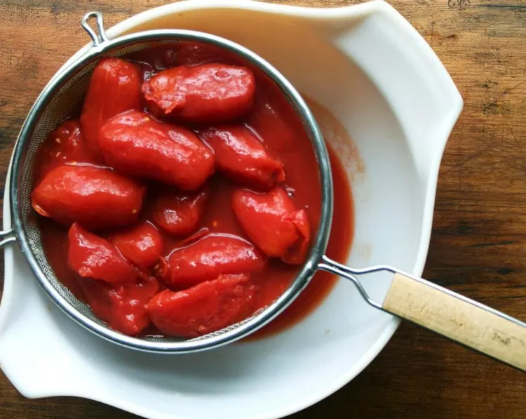 Step 1.1: Drain the whole peeled plum tomatoes through a sieve