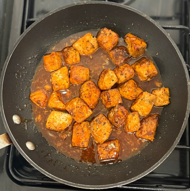 Step 2.1: Add the cooked salmon back into the pan and stir gently to avoid breaking the salmon