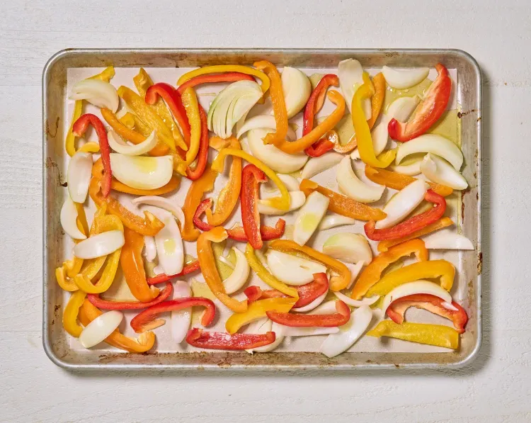 Step 1.1: Arrange bell peppers and onions on a parchment-lined sheet tray