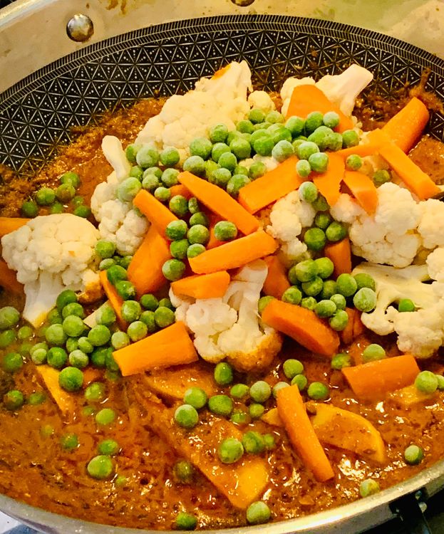 Step 1.1: Add the chopped vegetables (cauliflower, potatoes, diced carrots, peas, and sliced capsicum) and fry for 5-7 minutes until slightly softening