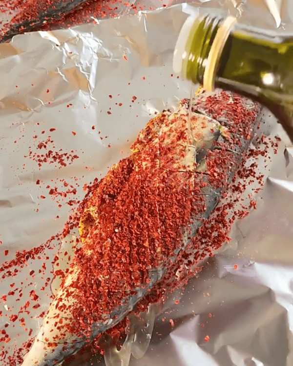 Step 4.1: Drizzle a generous amount of gochugaru chilli powder, add oil, and wrap fish individually