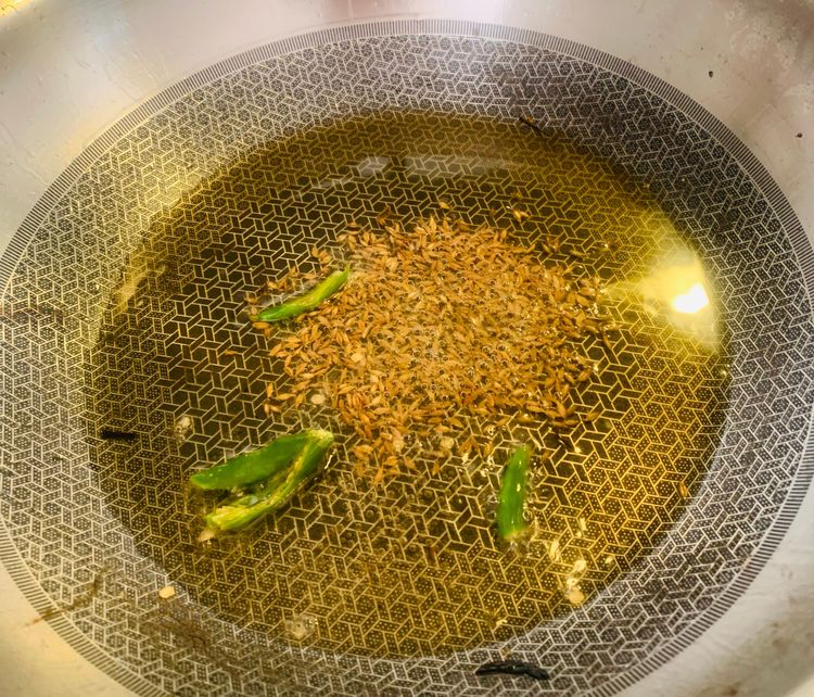 Step 1.1: Add cumin and green chillies to the same pan and let them crackle