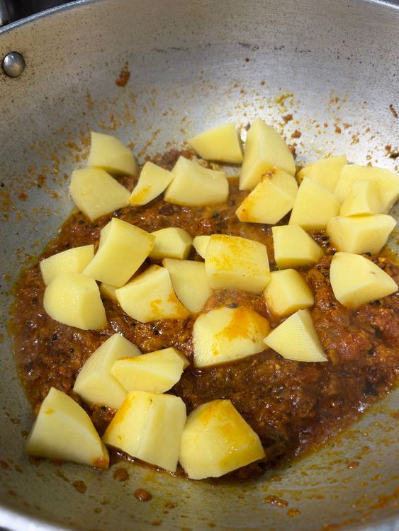 Step 3.1: Add the cubed potatoes, mix well, cover, and cook on medium-low heat for about 5 minutes, stirring once