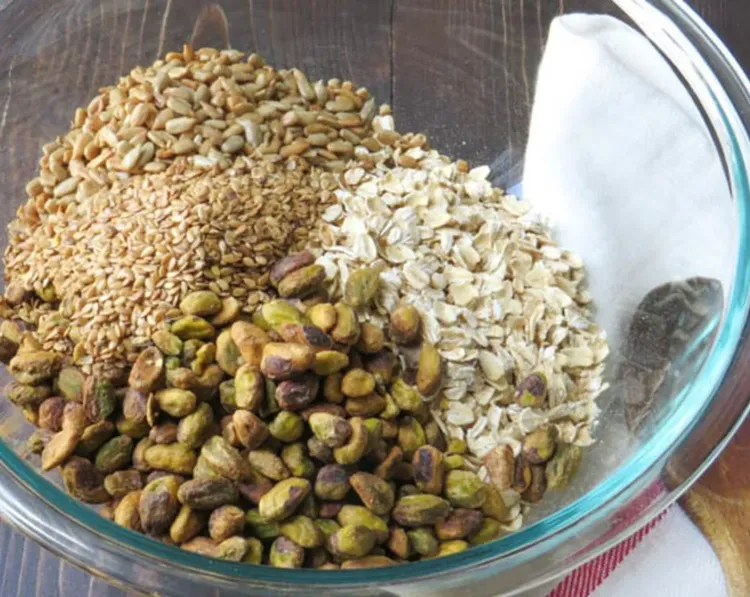 Step 2.1: In a large bowl, combine the old-fashioned rolled oats, roasted shelled pistachios, sunflower seeds, flaxseeds, sweetened coconut flakes, and a pinch of kosher salt