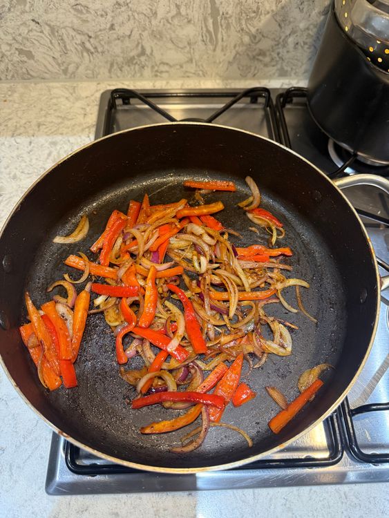 Step 3.1: In the same pan, add onion and bell peppers
