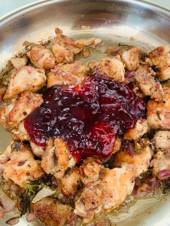 Step 3.1: Pour the prepared cranberry sauce mixture over the chicken, stirring gently to coat the chicken evenly with the sauce