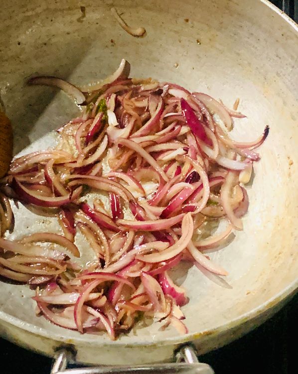 Step 2.1: Heat oil in a heavy-bottomed wok and add the chopped onions