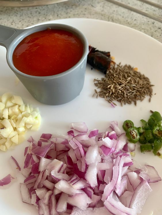 Step 1.1: Meanwhile chop the onions, garlic and green chillies and keep aside for tempering