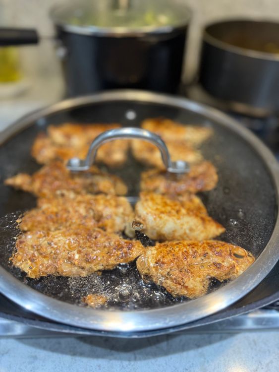 Step 2.1: Reduce the heat, cover the pan to create steam, and cook the chicken for about 15 minutes, adjusting the time based on the size of the pieces