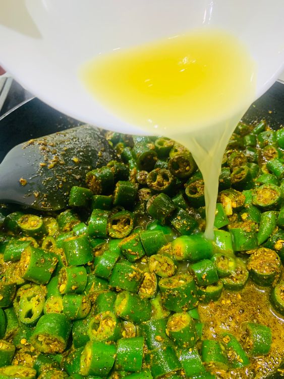 Step 1.2: Add the spiced green chillies to the pan and mix well to combine with the oil and garlic