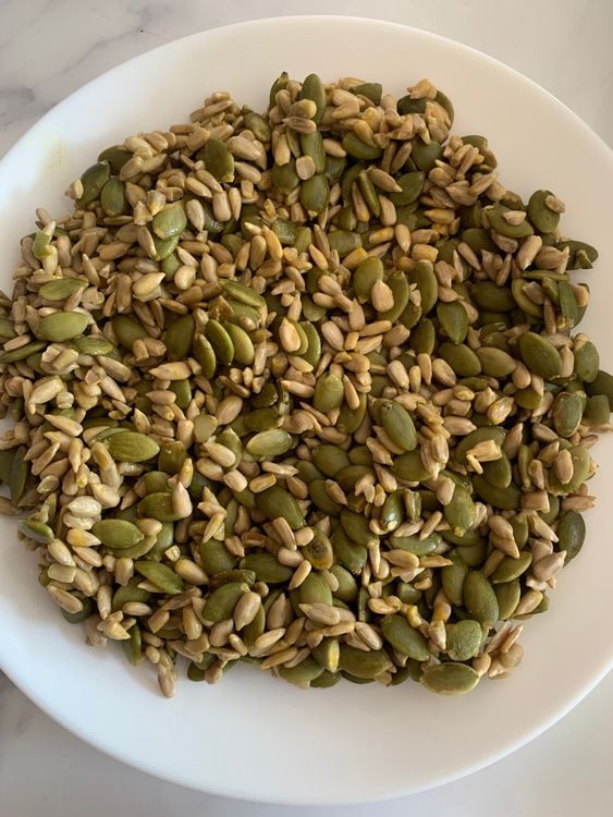 Step 2.1: In a separate bowl, combine the pumpkin and sunflower seeds