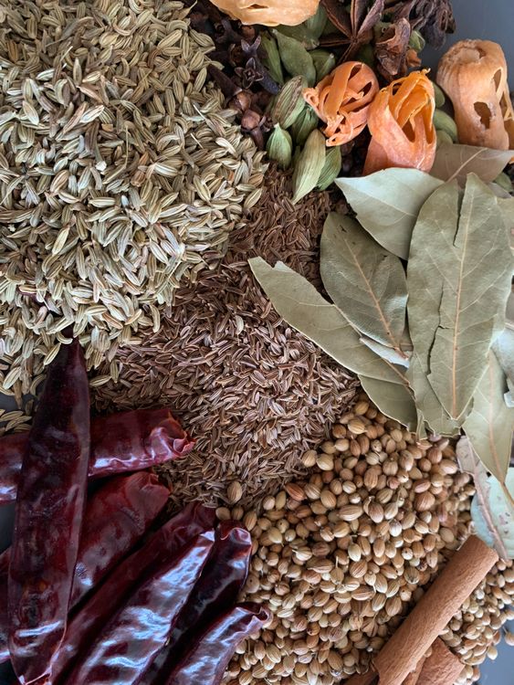 Step 1.1: Add green cardamom, mace, star anise, black peppercorns, nutmeg powder, coriander seeds, cinnamon, black cardamom, caraway seeds, dried pomegranate, dried red chillies, bay leaves, cloves and fennel seeds
