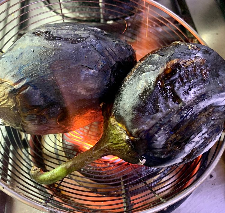 Step 1.1: Place the eggplants on a wire mesh and roast them on high heat for 8-10 minutes