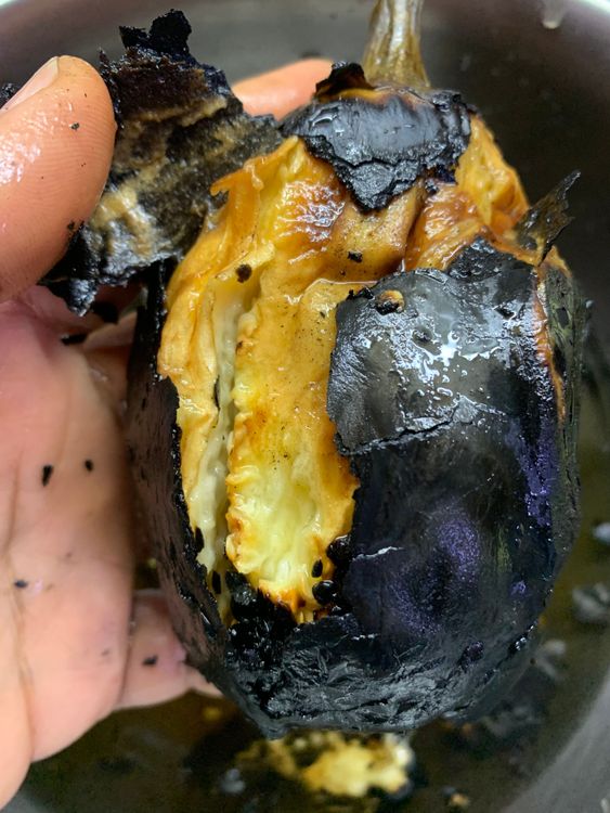 Step 1.1: Once cooled, remove the charred skin of the eggplants by gently pulling the skin with your hands