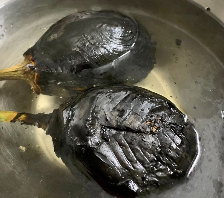 Step 1.1: Transfer the eggplants to a bowl of water and let them cool for 5 minutes