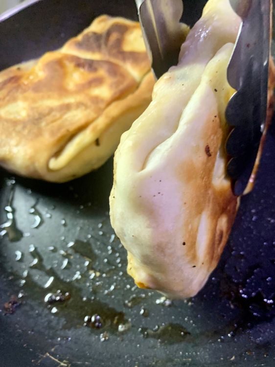 Step 3.4: Carefully flip the dough pocket with a spatula and continue frying for another 3-4 minutes, or until the dough pocket is  is golden brown and crispy from all sides