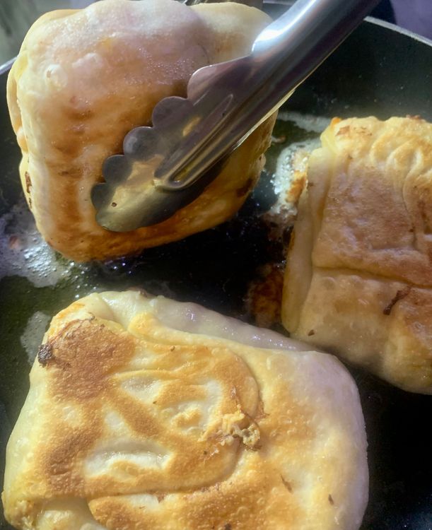 Step 3.2: Carefully flip the dough pocket with a spatula and continue frying for another 3-4 minutes, or until the dough pocket is  is golden brown and crispy from all sides