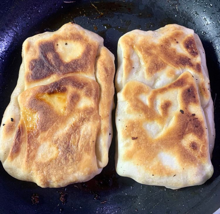 Step 3.3: Carefully flip the dough pocket with a spatula and continue frying for another 3-4 minutes, or until the dough pocket is  is golden brown and crispy from all sides