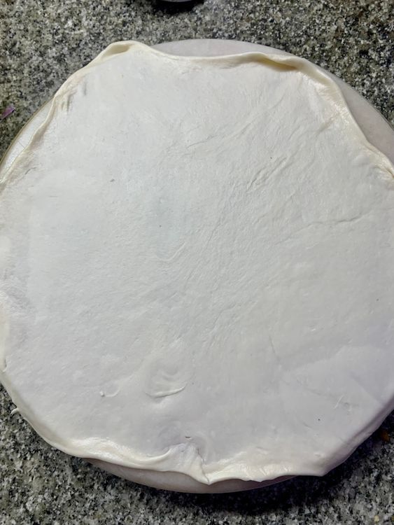 Step 3.3: Place the dough ball on a flat surface and carefully roll the ball with a rolling pin into a circle as thin as you want