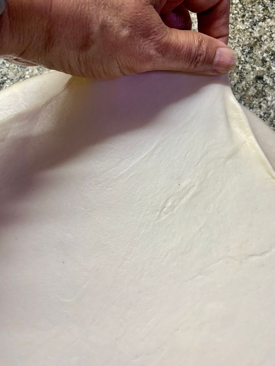 Step 3.1: Place the dough ball on a flat surface and carefully roll the ball with a rolling pin into a circle as thin as you want