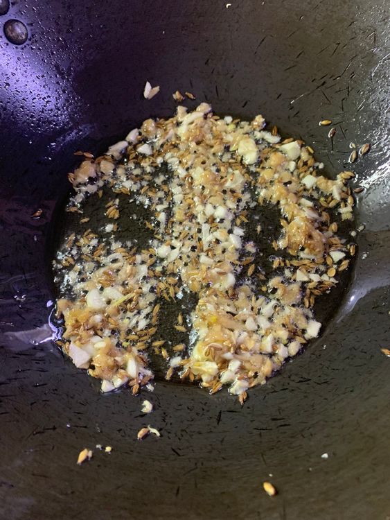 Step 2.1: Add the chopped ginger and garlic and cook for a minute