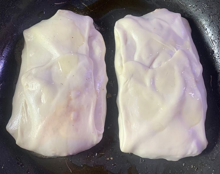 Step 3.1: Gently place the dough pocket into the hot oil and shallow fry for about 3-4 minutes