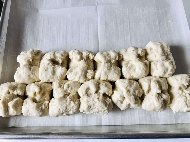 Step 2.1: Arrange the dough balls into a large triangle on the baking sheet, starting with 7 balls at the base