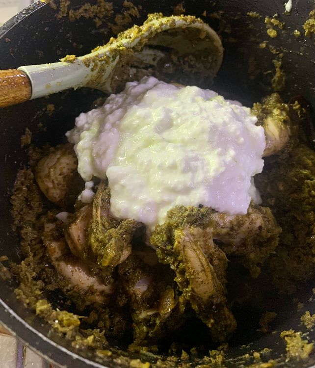 Step 2.1: Once the chicken pieces have lightened in colour, add curd, stir and wait for a boil
